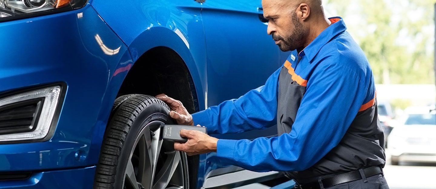 Quick Lane technician servicing a vehicle